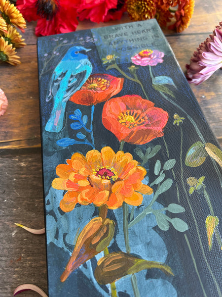 Floral painting of Indigo Bunting bird on a canvas surface with poppies and zinnias.