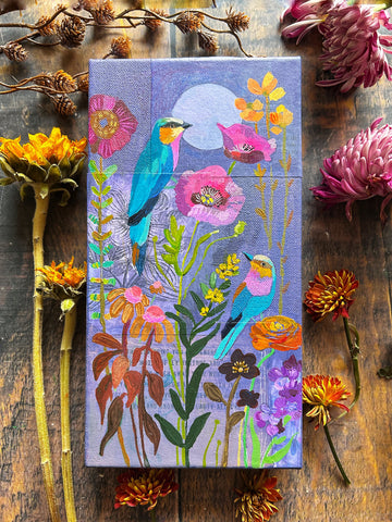 Colorful painting with floral and roller bird design on a canvas surface with flowers and branches.